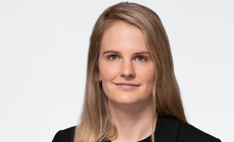 Lauren has a side part in her long blonde hair.